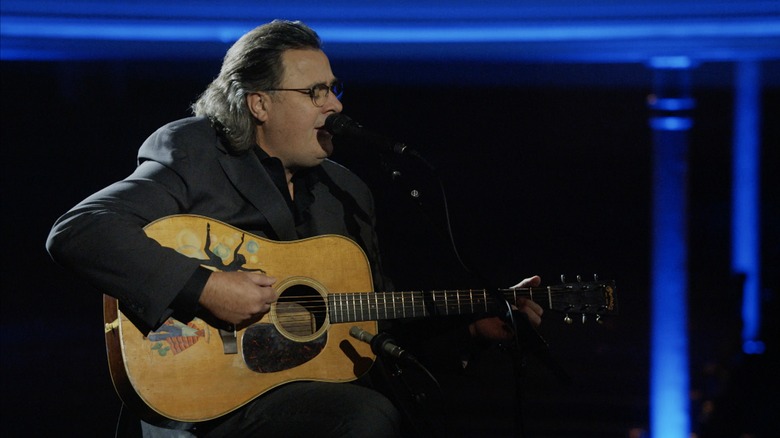 Vince Gill playing guitar and singing