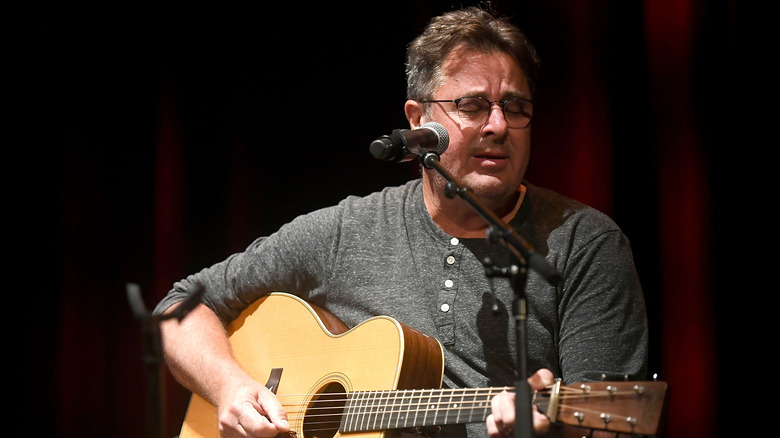 Vince Gill playing acoustic guitar