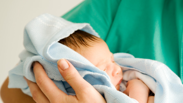 A nurse holding a baby