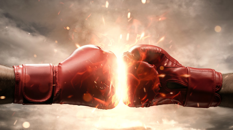Two boxing gloves colliding