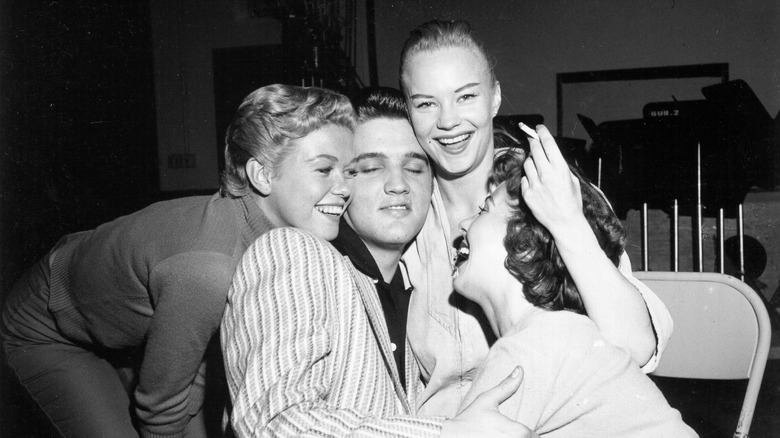 Elvis Presley and fans backstage in 1956