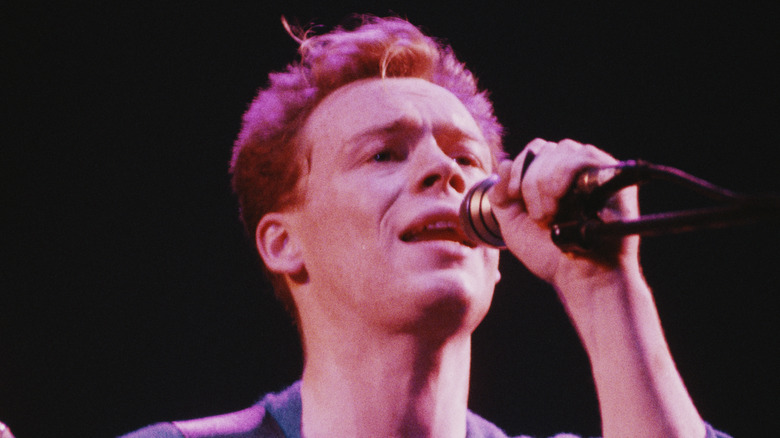 Ali Campbell of UB40 singing on stage in 1980