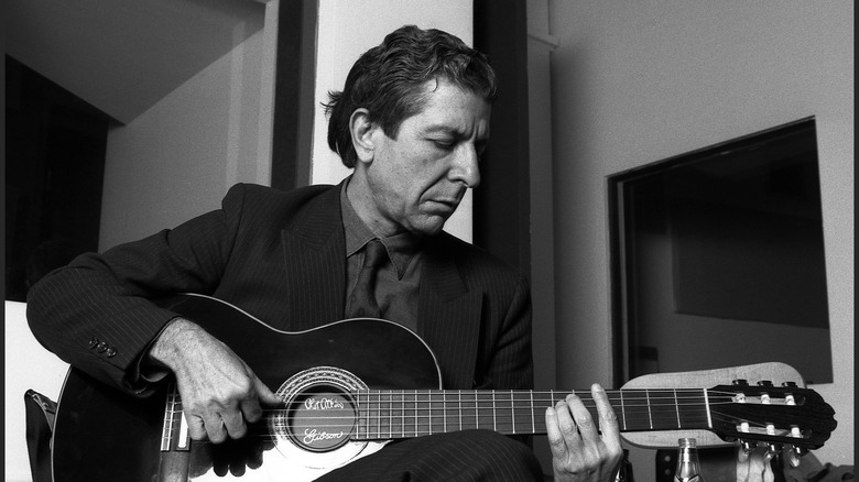 Leonard Cohen playing guitar