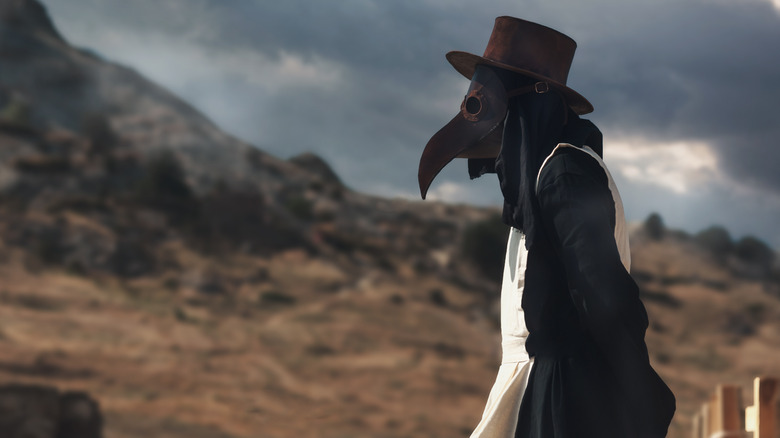 Person wearing plague doctor costume 