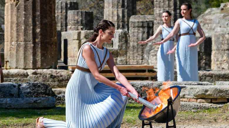 woman lighting torch olympics tokyo games