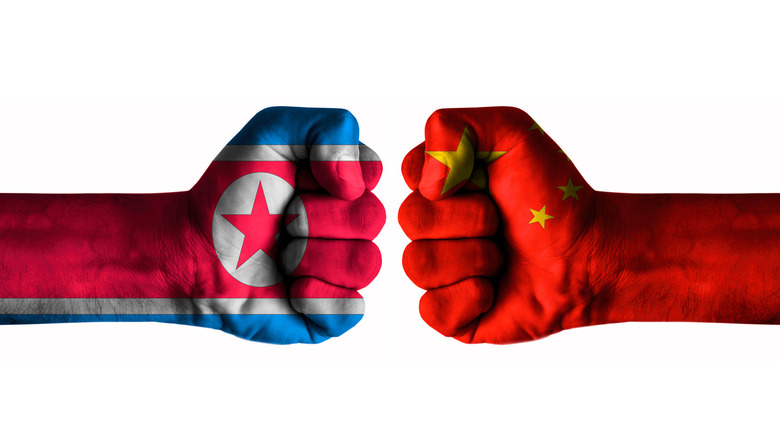 North Korean flag fist Chinese flag fist