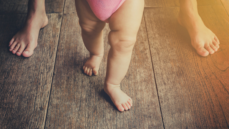 toddler with person walking