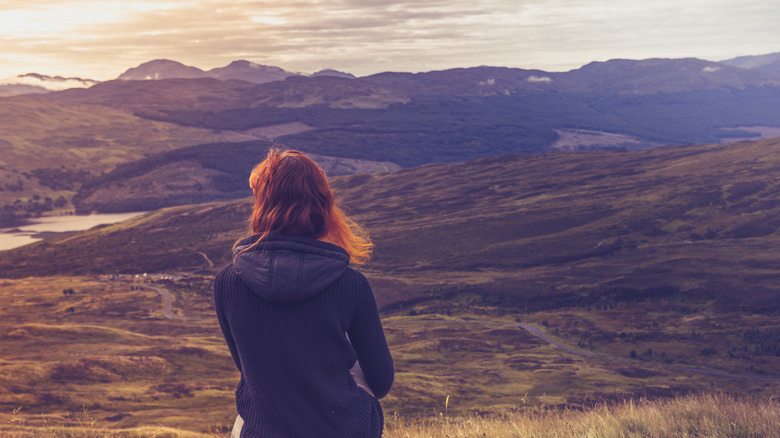 woman admiring sunset and sublime nature