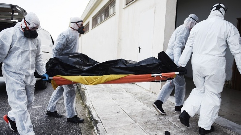 Hazmat carrying a body bag