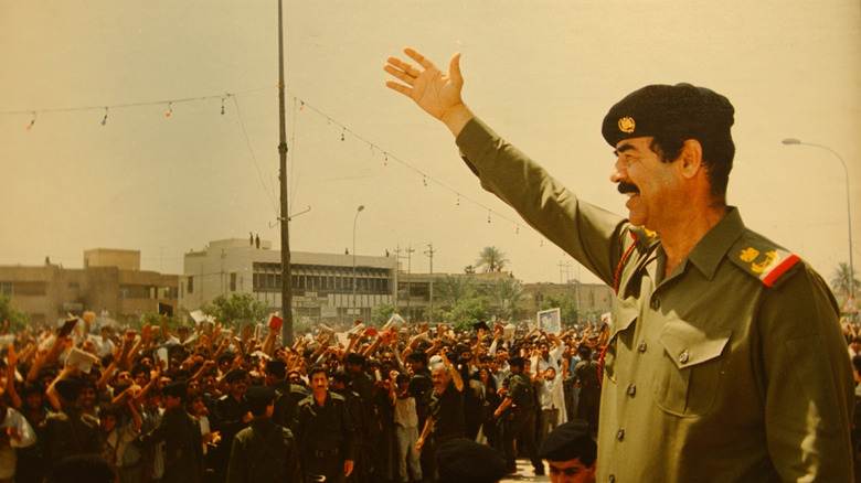 Saddam Hussein waving to crowd