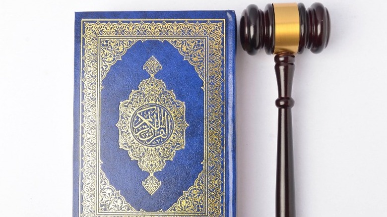 The Quran and a law gavel