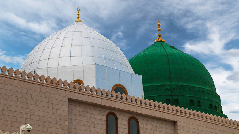 white and green mosque domes under blue sky