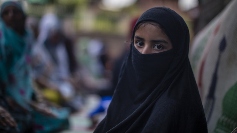 A burqa-clad woman staring