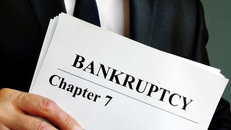 Man holding bankruptcy papers