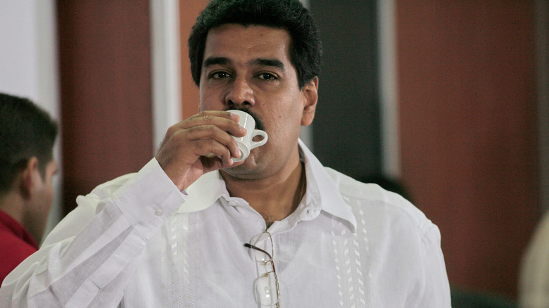 Nicolás Madura sipping from a cup