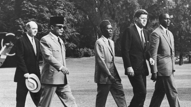 John F. Kennedy walks with and President Sukarno