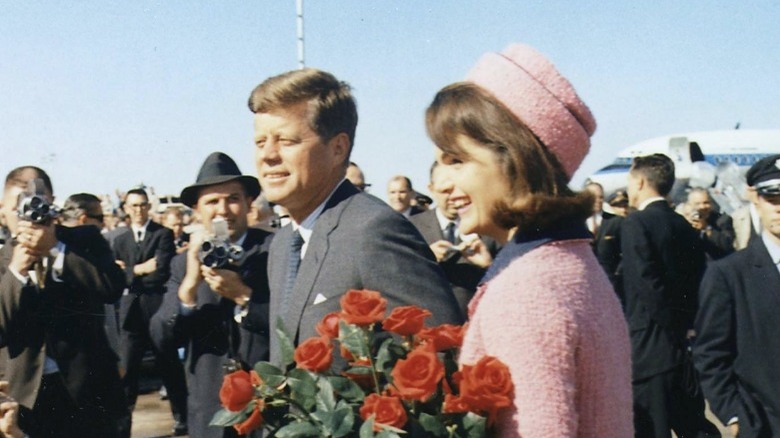 John F. Kennedy and Jackie Kennedy smiling in Dallas Love Field