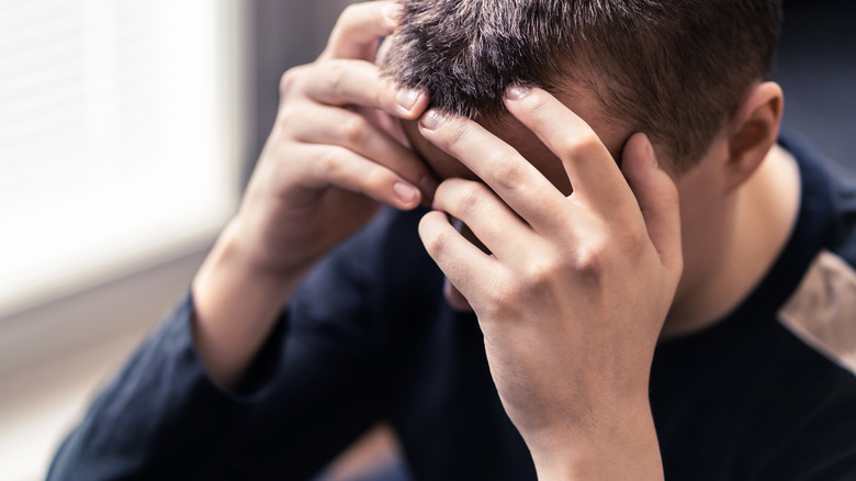 Man holding his head