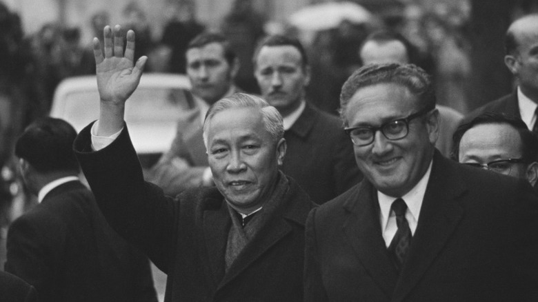 Kissinger and Le Duc Tho smiling 