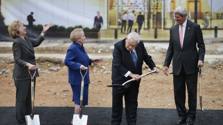 Kissinger, Clinton, Kerry holding shovels