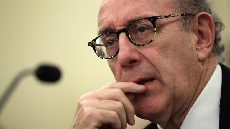 kenneth feinberg with a microphone behind him