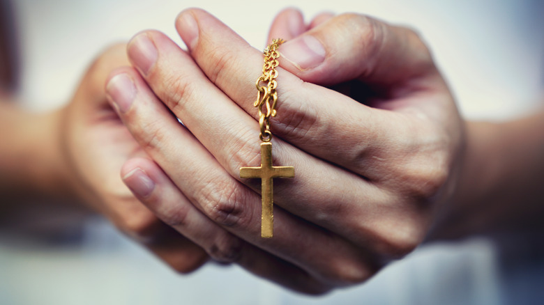 hand holding crucifix