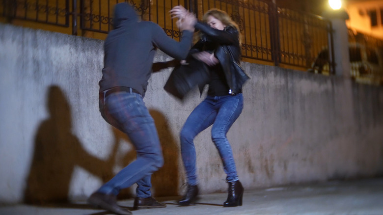 man attacking woman at night