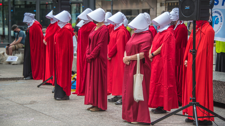 women dressed as handmaid