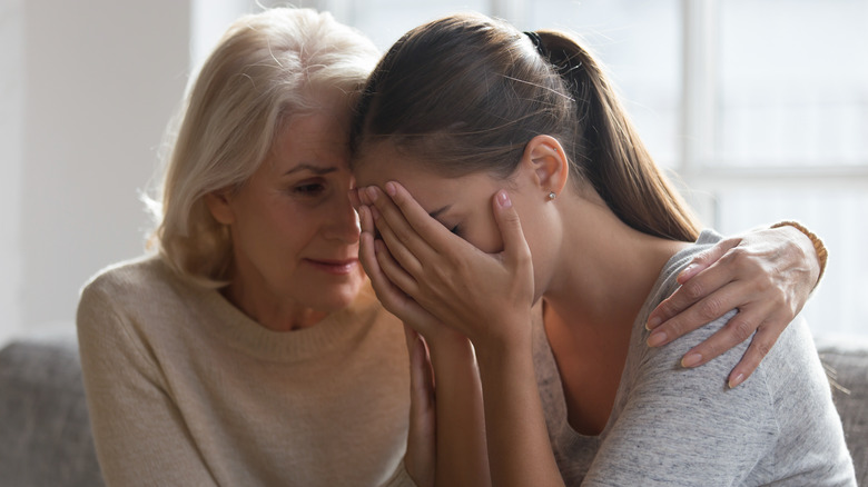 Upset woman being comforted