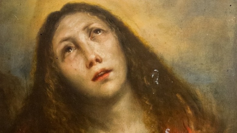 Painting of Mary Magdalene with a light behind her head and looking upwards