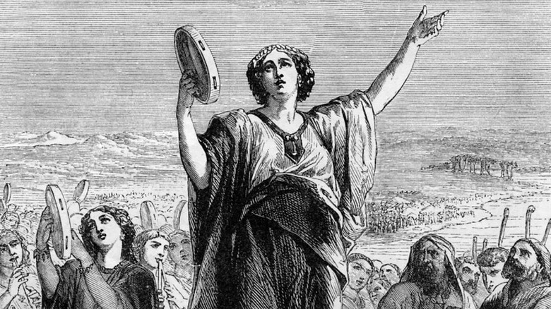 Miriam holding a tambourine leading people across the Red Sea with song and dance