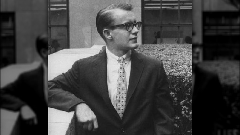 Michael Rockefeller leaning on a barrier 