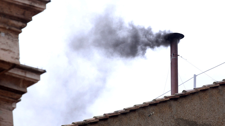 Black smoke from the chapel's chimney
