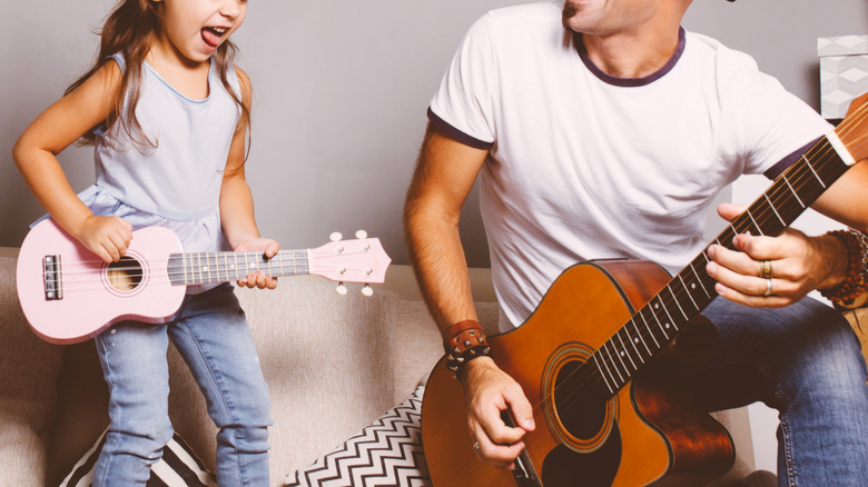 Kid and adult with guitars
