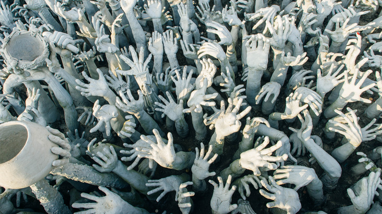 hands reaching out in purgatory