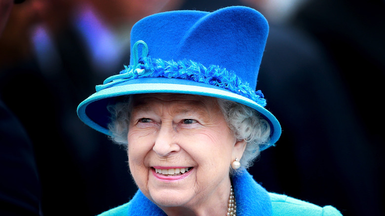 Queen Elizabeth smiling blue hat