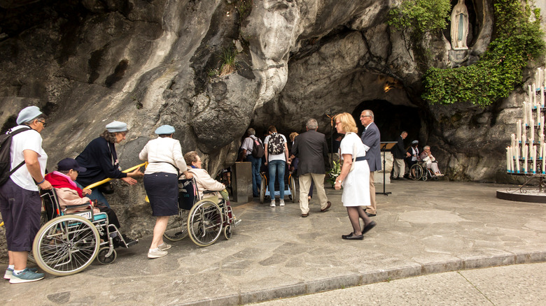 Volunteers bringing the sick to Lourdes