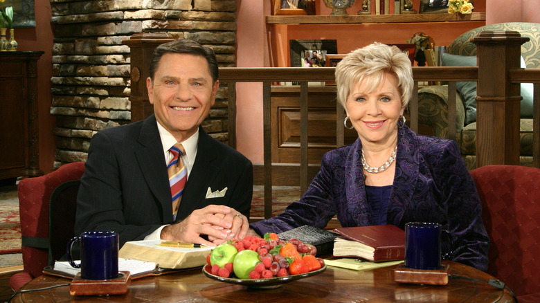 Kenneth Copeland holding hands with his wife