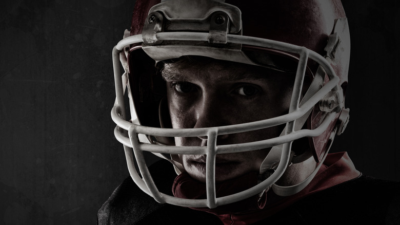 angry man in old time football helmet