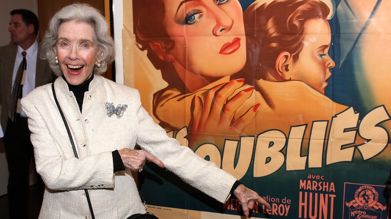 Marsha Hunt pointing to poster