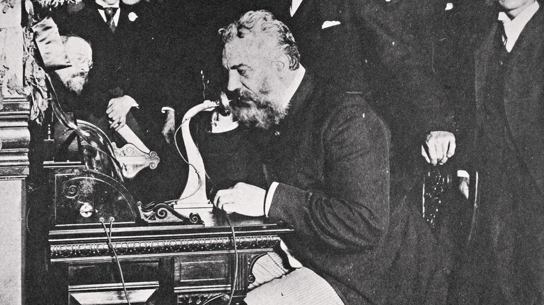Alexander Graham Bell making first telephone call