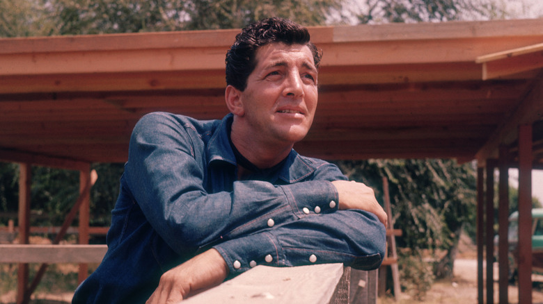 Dean Martin, leaning on fence