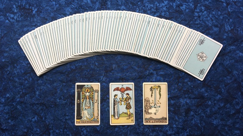 Photo of a 3 card tarot spread. The deck is the Smith-Waite Centennial Tarot Deck