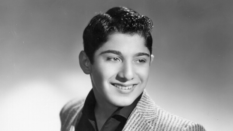 Young Paul Anka smiling suit