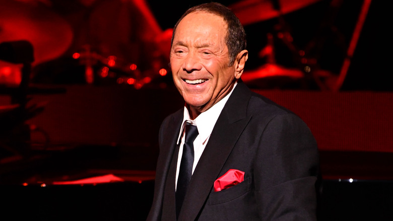 Paul Anka smiling in suit on stage