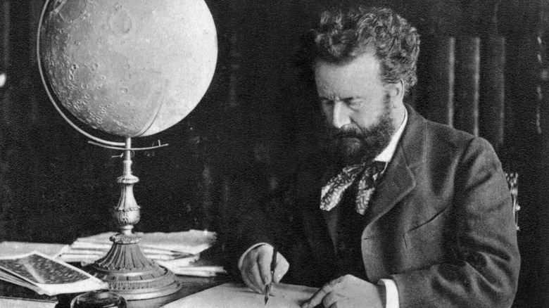 Camille Flammarion writing at desk