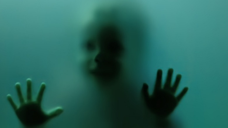 child's ghost behind glass