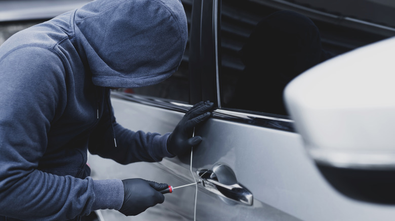 Person trying to break into a car