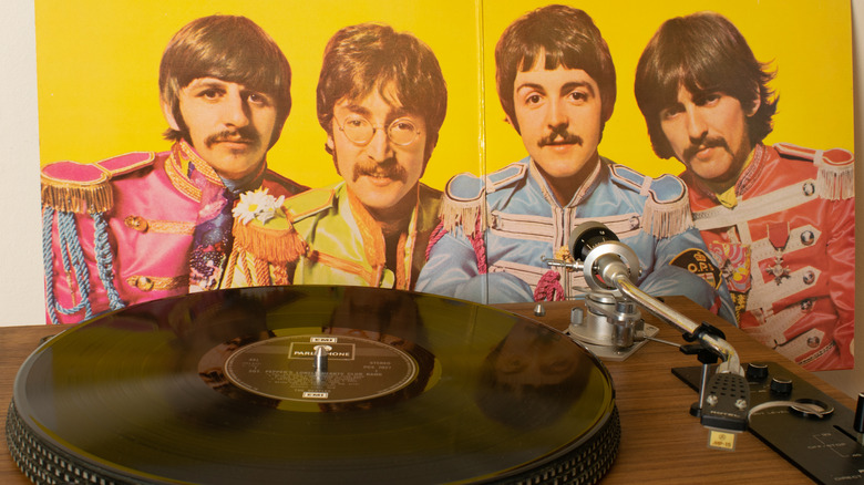 Record player next to Sgt. Pepper poster