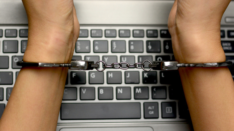 Person handcuffed on keyboard